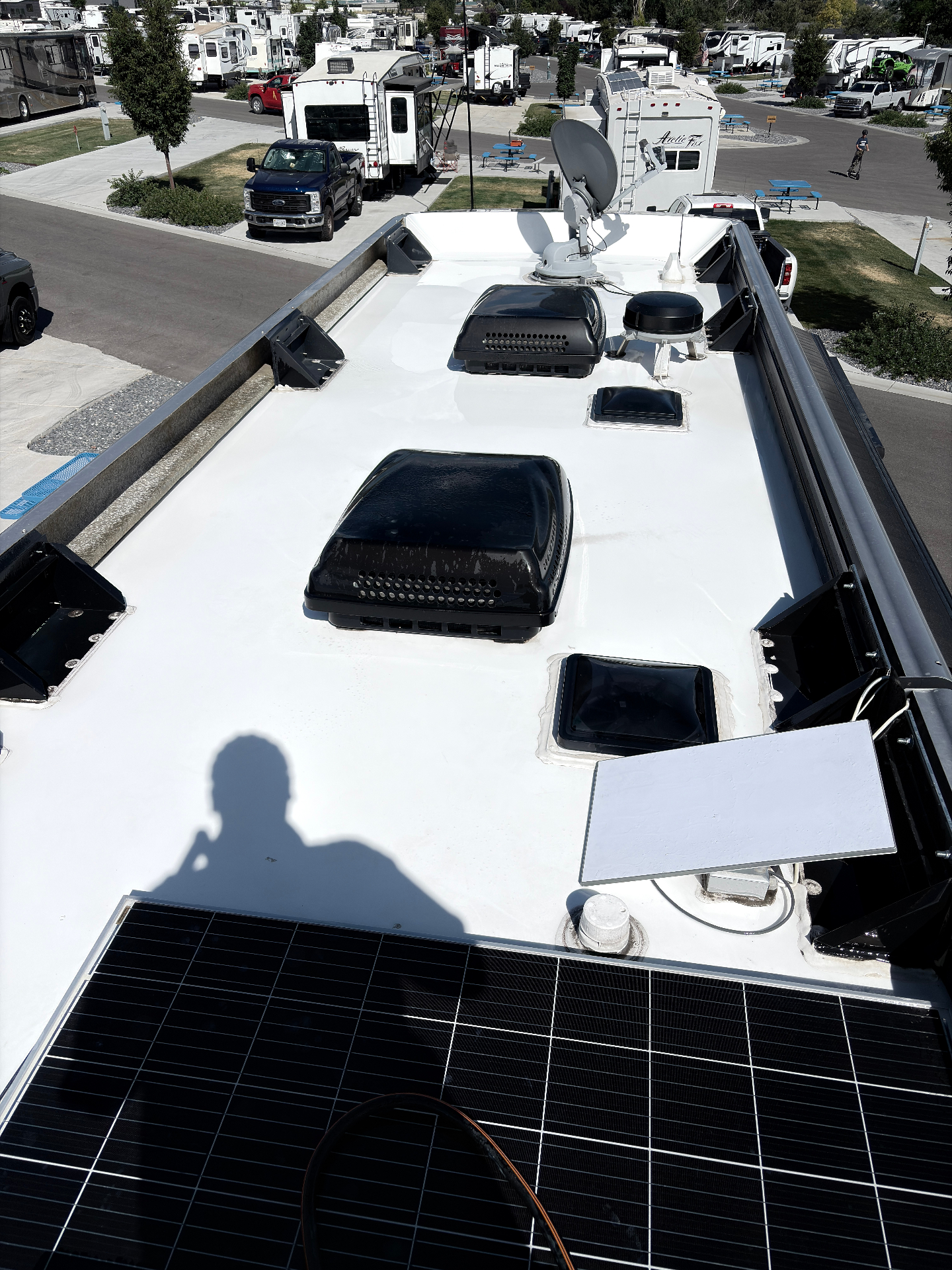 RV roof after cleaning, bright white membrane with clean solar panels